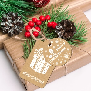 Close-up of brown kraft paper Christmas gift tags with hemp rope on gift box