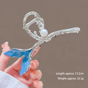 Detail of silver mermaid tail hair claw clip with blue gradient and pearl, 13.2cm length