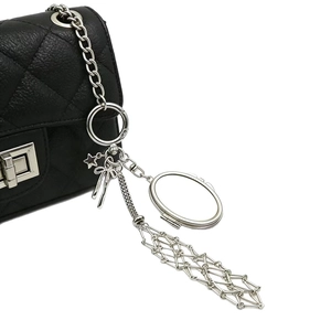 Black quilted bag with silver chain strap and metal mesh mirror bow keychain pendant
