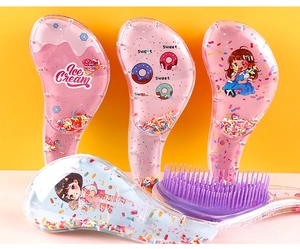 Detail of cute transparent detangling hairbrushes with colorful sequins and ice cream art