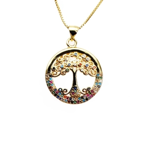 Macro shot of gold tree of life necklace pendant with multicolored zircon inlay