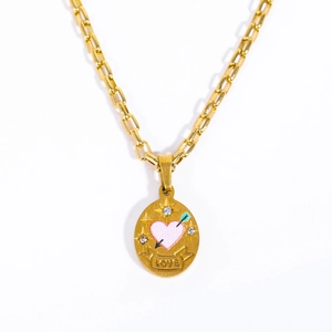 Close-up of golden oval pendant featuring pink heart, arrow, and LOVE engraving