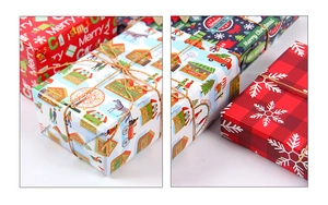 Close-up of Christmas wrapping paper with red snowflakes and festive village patterns