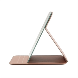 Portable pink PU leather folding makeup mirror standing on a desk with a clear view