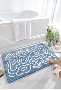 Tappetino da bagno blu assorbente con motivi astratti bianchi e morbida texture felpata