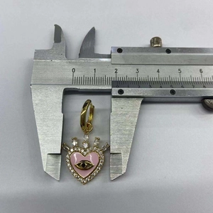 Macro shot showing pink enamel heart pendant size with zircon evil eye detail