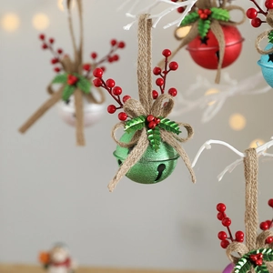 Christmas tree bells hanging ornaments with red berries and bow ties on white branches