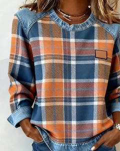 Detail of plaid sweatshirt with denim trim neck and cuffs on female model