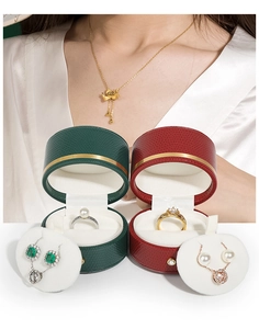 Deep green and red textured leather jewelry boxes featuring elegant gold trim and pearl jewelry