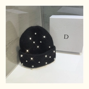 Detailed macro shot of black knit beanie featuring luxury rhinestone embellishments
