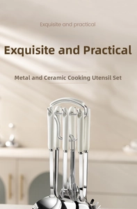 Close-up of stainless steel kitchen utensil set with white ceramic handles and storage rack