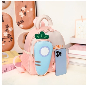 Close-up of pink toddler backpack featuring a 3D blue carrot pocket and mesh side bag