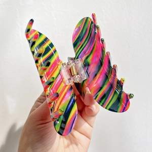 Colorful striped butterfly hair claw clip with rhinestones and vibrant neon pattern