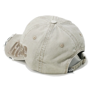Close-up of distressed beige cap showing RARE embroidery and adjustable metal strap