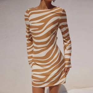 Detail of zebra print texture and slim fit design on long sleeve mini dress