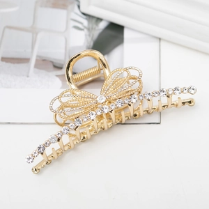 Golden butterfly hair claw clip with sparkling rhinestones in a luxury metallic finish