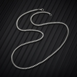 Close-up of a silver stainless steel box chain necklace with sleek metallic finish