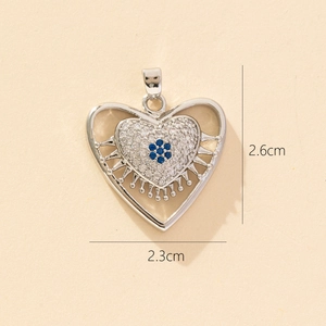 Detailed view of silver heart pendant with blue gemstone flower and dimension markers