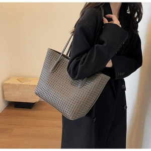 Close-up of grey-green woven tote bag showing detailed handcrafted texture and large size