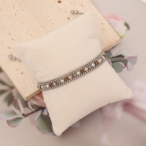 Bohemian braided bracelet with silver metal chains and faceted crystal beads on display