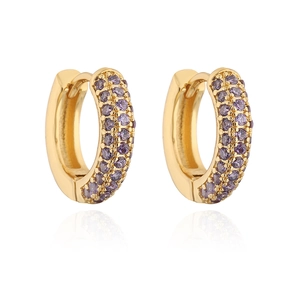 Macro shot of gold-plated huggie earrings with triple-row purple zirconia stones