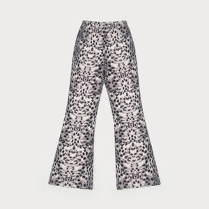 Close-up of black and white leopard print flared pants with comfortable elastic high waist