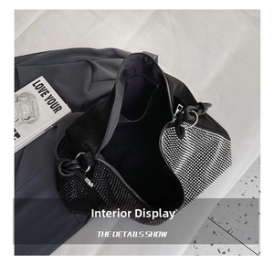 Detailed interior view of a black rhinestone tote bag with a secure zipper pocket