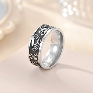 Detailed side view of vintage steel ring with black enamel geometric engravings