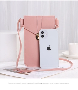 Pink PU leather crossbody phone bag with gold twist lock showing size comparison to a phone