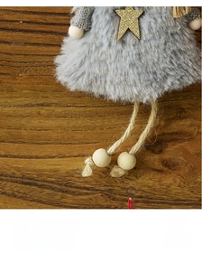 Close-up of plush heart angel ornament with gray faux fur skirt and golden star detail