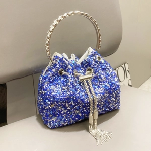 Detail of blue bucket bag with sparkling sequins and rhinestone-encrusted round handle