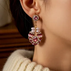 Vintage round pave-set crystal tassel earrings worn on person for an elegant look