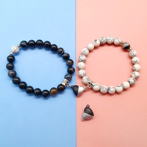 Detail showing strong magnetic heart clasps on black and white marble stone bracelets
