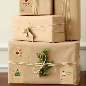 Brown kraft paper Christmas gift labels with festive holiday patterns and twine on gift boxes