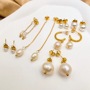 Detailed set of 14K gold plated stainless steel earrings with white freshwater pearls