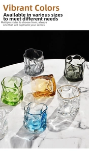 Macro shot of colorful rippled glass tumblers with unique origami texture on marble