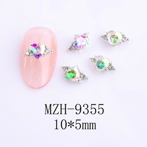Detail view of 10x5mm heart-shaped aurora nail rhinestone on pink manicure