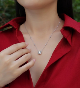 Detail of 925 sterling silver necklace featuring square moissanite pendant and gem chain