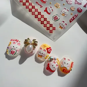 Detailed view of 3D embossed nail art stickers featuring red lucky bags and white rabbits