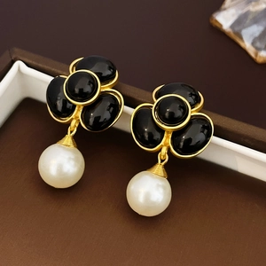 Vintage black flower pearl drop earrings with gold metal accents in a classic 1980s style