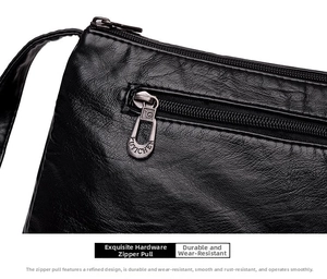 Gros plan sur la fermeture éclair en métal et le logo du sac en cuir noir grainé