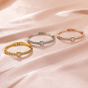 Elegant gold and silver heart bracelets with sparkling rhinestones on satin fabric
