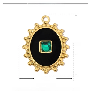 Detail view of green crystal pendant with gold frame and enamel, size 29mm by 22mm