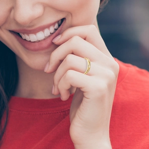 Detail of gold moissanite star ring shown on a model hand with premium lighting