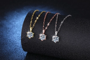 Detailed close-up of six-prong moissanite necklaces in gold, rose gold and silver finishes