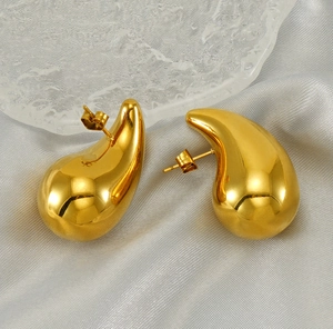 Macro shot of 18K gold plated hollow teardrop earrings with polished mirror surface