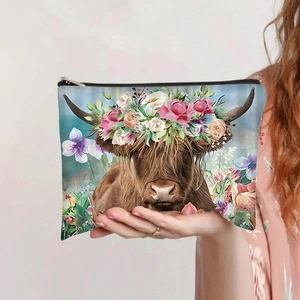 Detail of high-capacity makeup bag with highland cow print and floral crown design