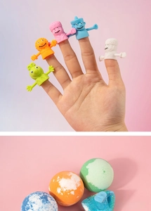 Close-up of five colorful silicone finger puppets and three fizzy bath bombs for kids' spa