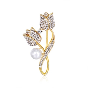 Detailed view of golden tulip brooch with white crystals and a center round pearl