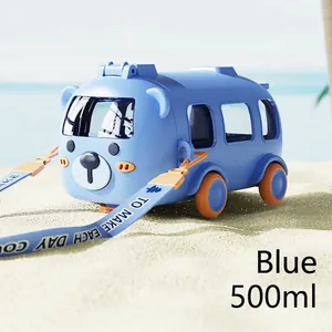 Close-up of a 500ml blue bear bus kids water bottle with strap on a beach background